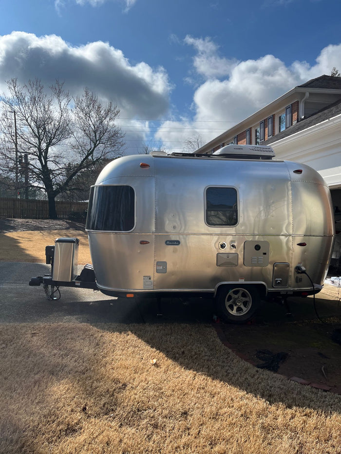 perfect for your next RV rental adventure or camping trip. Ready for vacation!|Visually: A gleaming silver Airstream travel trailer