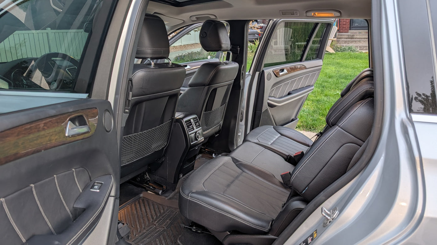View of an SUV's spacious rear and third-row leather seats. A great option for family travel, even as an rv rental alternative.