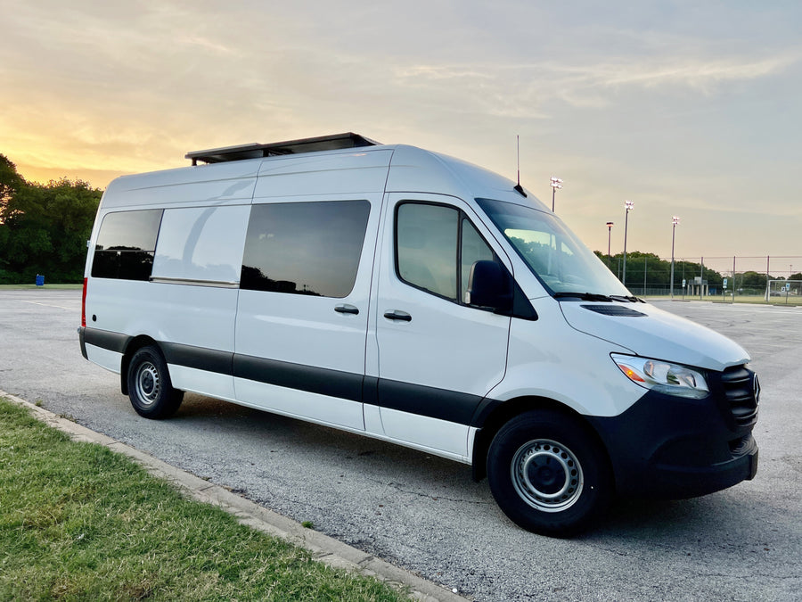 Modern white camper van with solar panels for RV rental