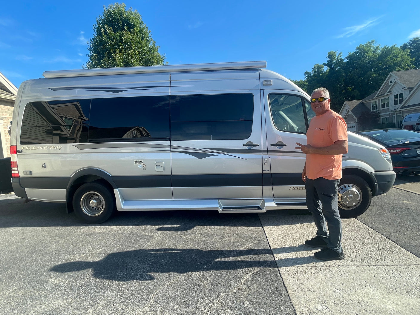 and a black glass cooktop next to a large window.|Glimpse inside an RV rental: White leather seats
