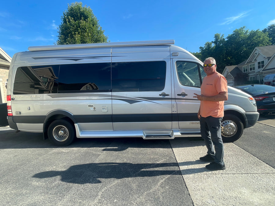 and a black glass cooktop next to a large window.|Glimpse inside an RV rental: White leather seats