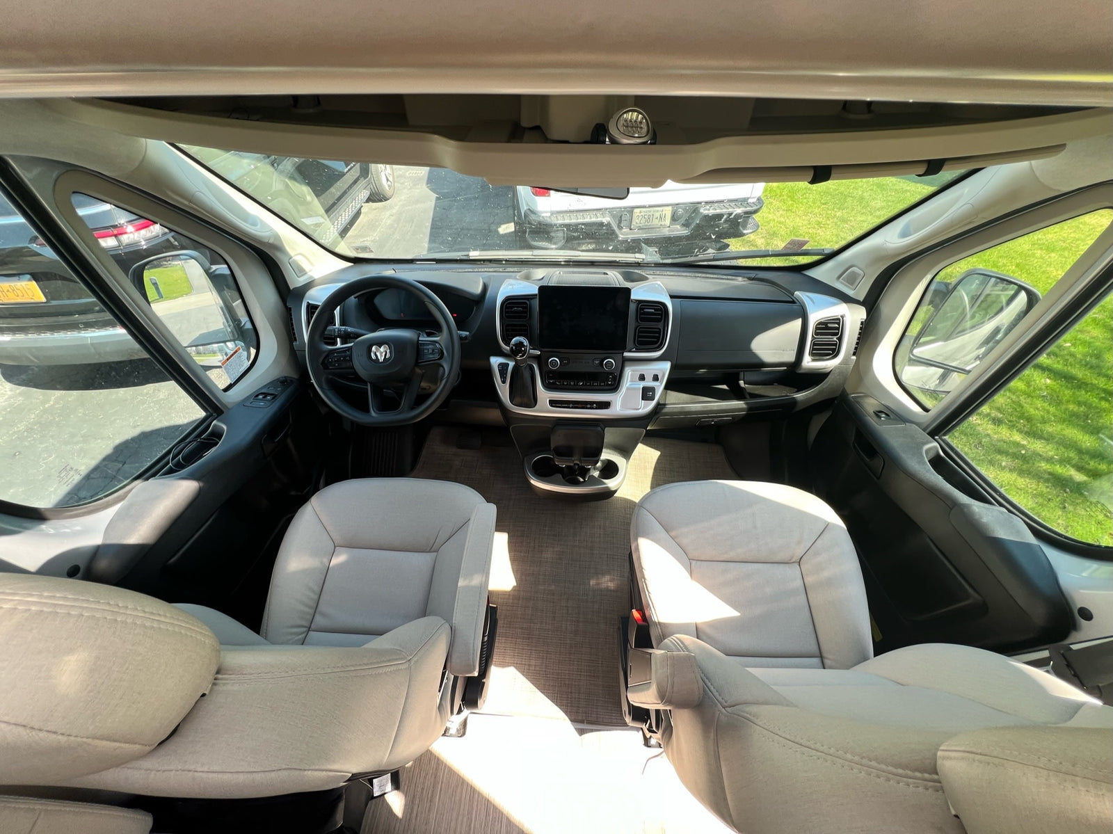 and cargo is parked in a wooded campground setting.|Spacious rv rental interior featuring a modern kitchen