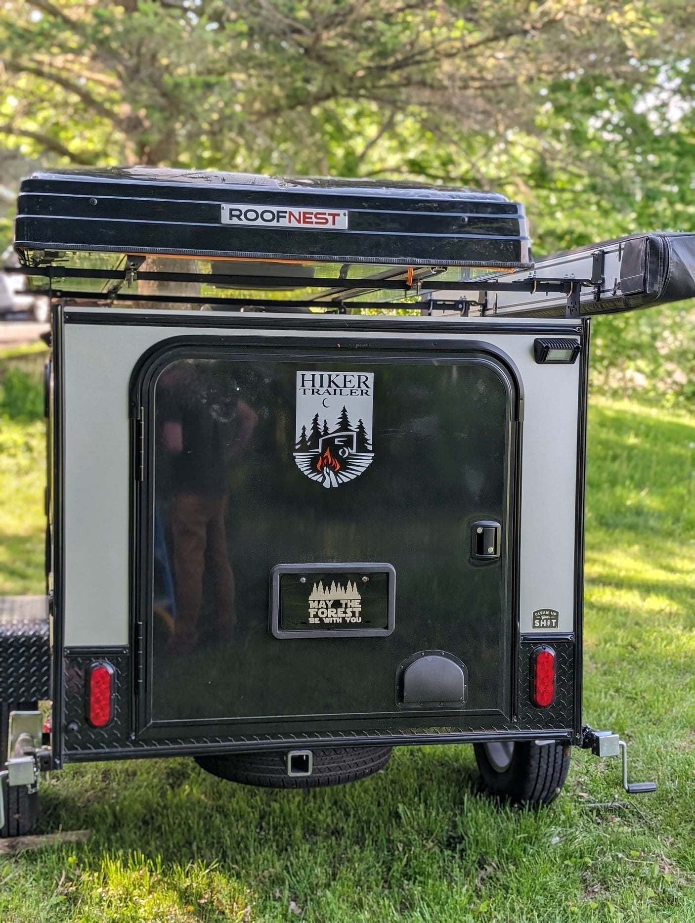 ideal for nature lovers and outdoor adventurers.|A "Clean Up Your SH*T" sticker with a tree design on an RV rental