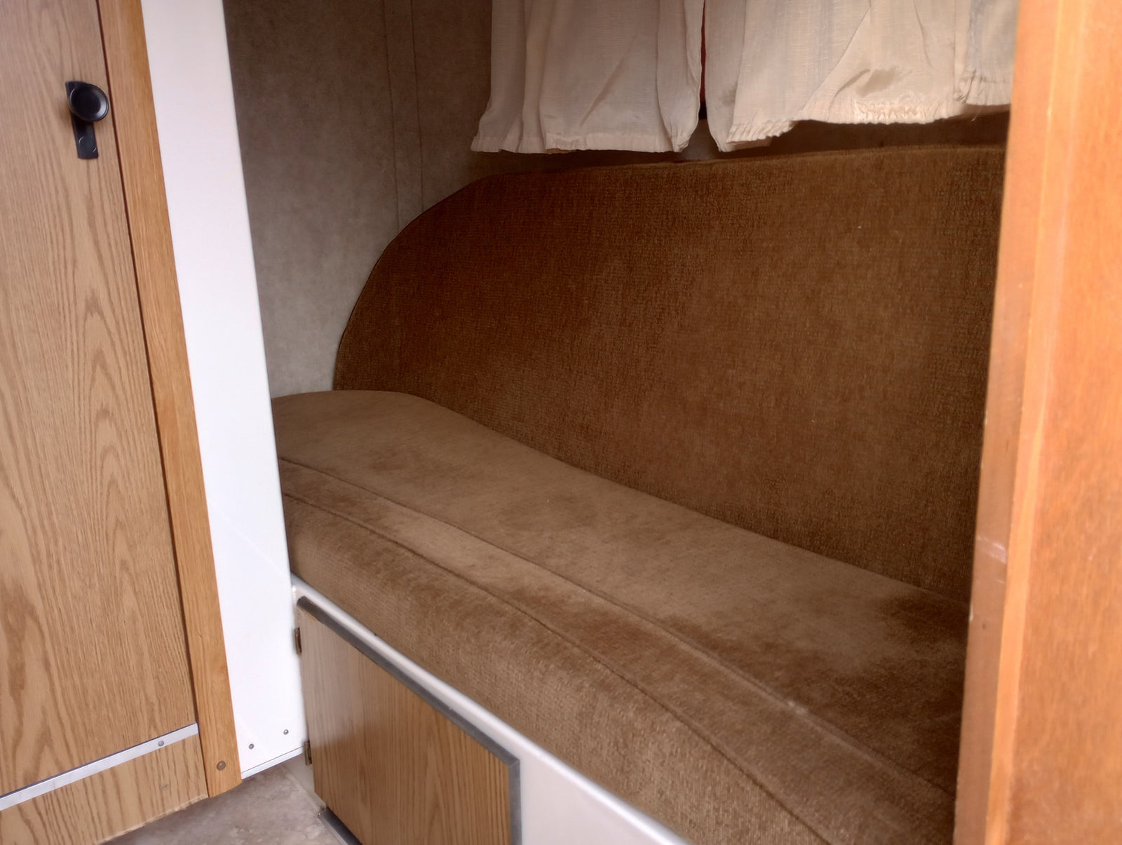 and air conditioning.|RV rental interior showcasing a compact kitchen with Dometic fridge
