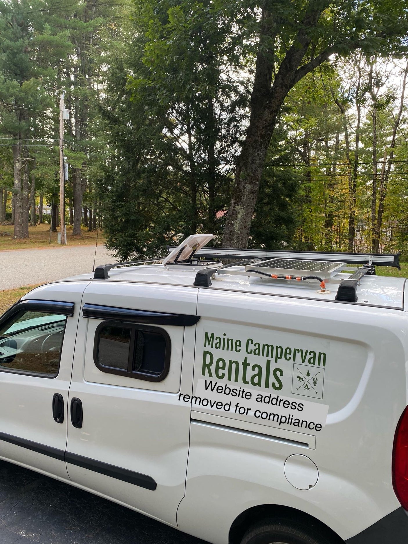 & storage. Perfect RV rental.|White RV rental van at Moosehead Marine Museum with the historic Katahdin steamboat. Great for waterfront travel!|Enjoy a cozy RV rental evening! Wine