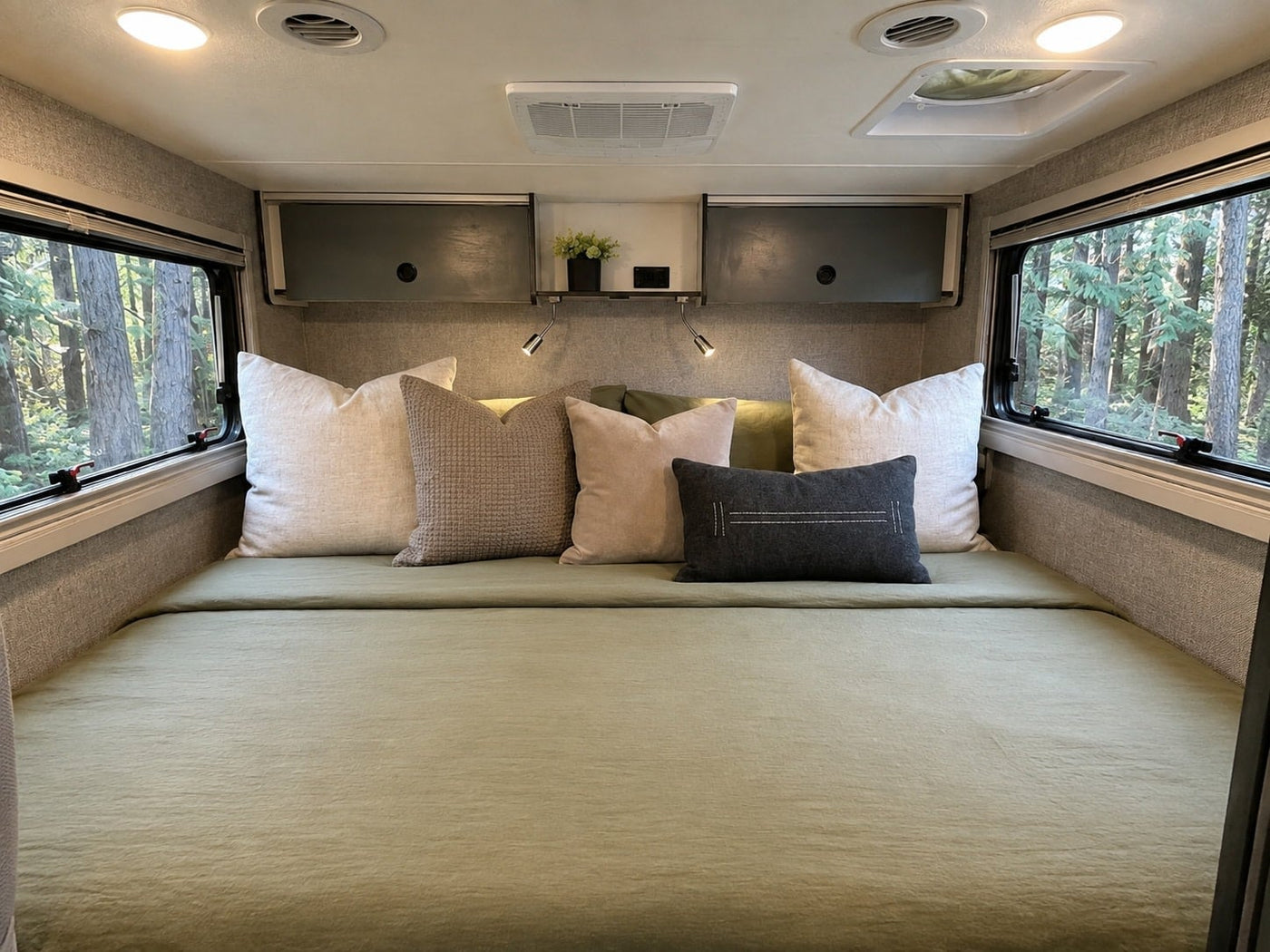and pines.|Modern RV rental interior showing a compact kitchen — photo 8