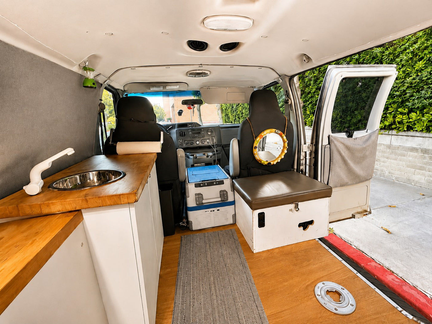 Inside a modern rv rental camper van: kitchenette, custom seating, and ample storage for comfortable travel.