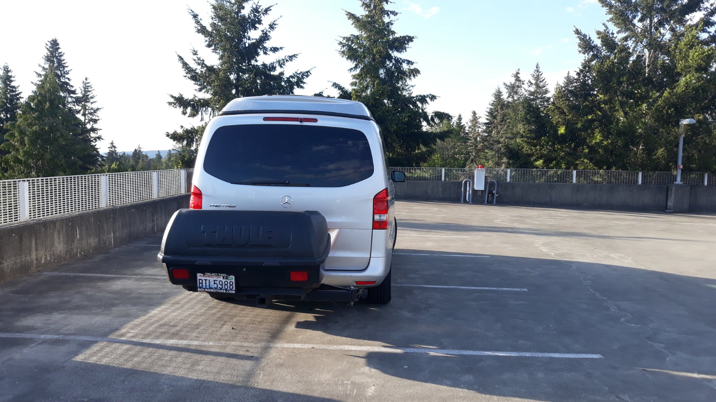 Silver Mercedes-Benz Metris camper van with Thule cargo box. An ideal RV rental for your next outdoor adventure.