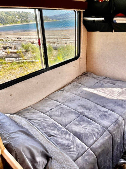 and an 'Oregon' sign.|RV rental kitchen with a black two-burner stovetop