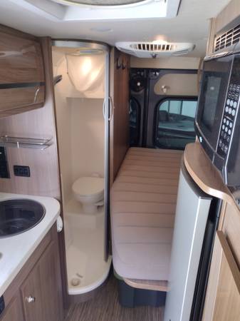 ready for RV rental adventures.|A dark grey ProMaster Class B RV