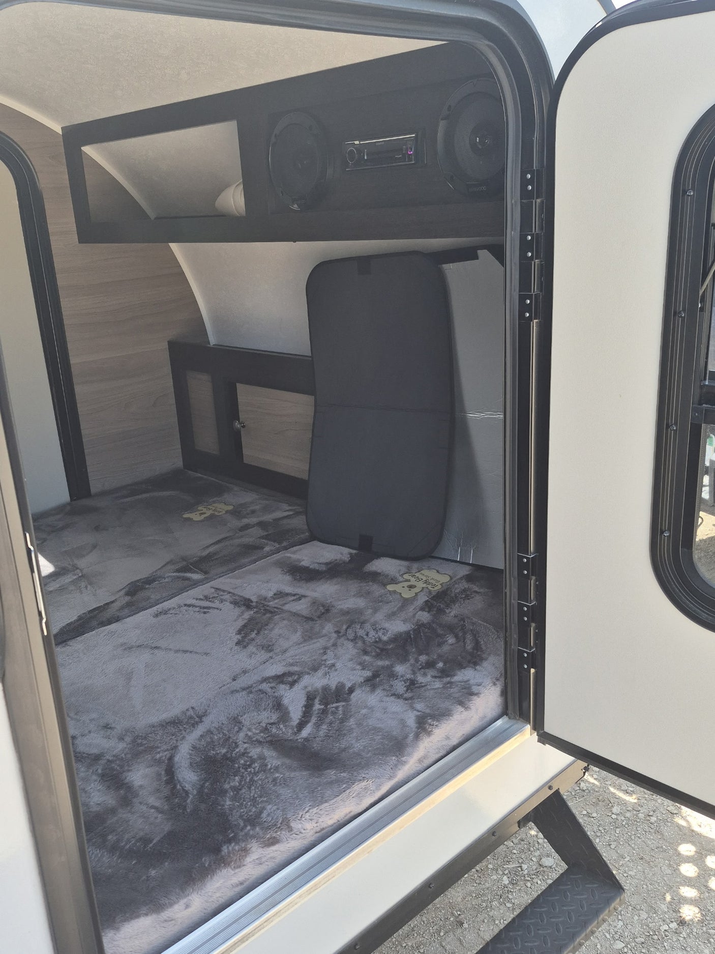 is ready for adventure.|Compact RV rental interior featuring a comfy bed