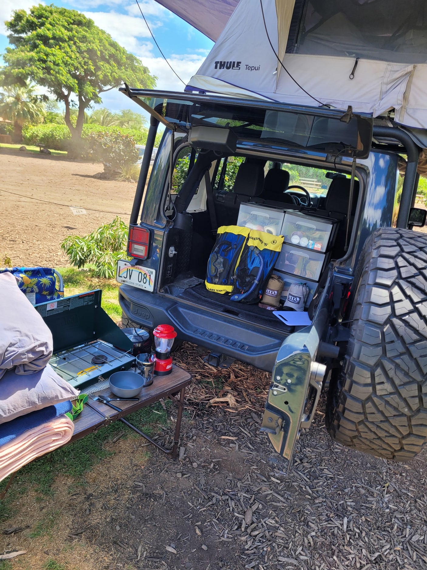 Hawaii camping with an RV rental alternative: a Jeep Wrangler with rooftop tent, camp kitchen, and organized gear.
