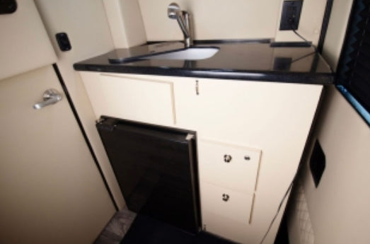 and scenic window views.|Tour this luxury RV rental's spacious interior: cream captain's chairs