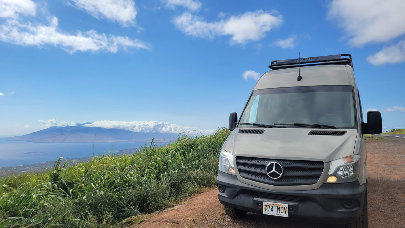 Hawaii RV rental: Mercedes Sprinter van with ocean & island views from a scenic mountain road.