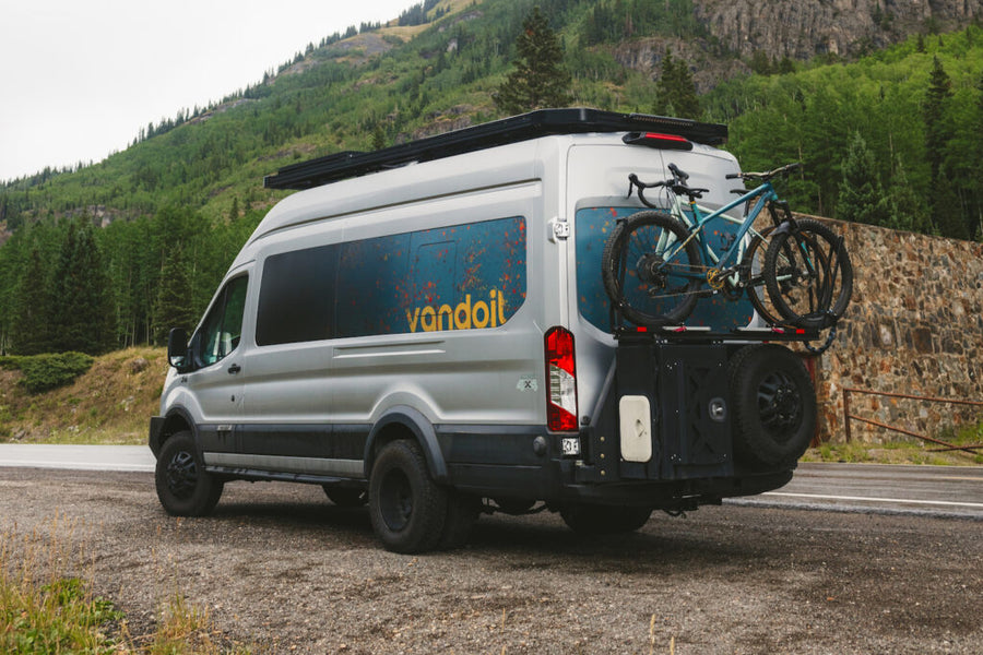 Explore scenic mountains with this silver custom RV rental van