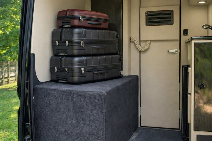 and dark wood accents for premium comfort.|Rear view into an RV rental's compact interior: toilet on left