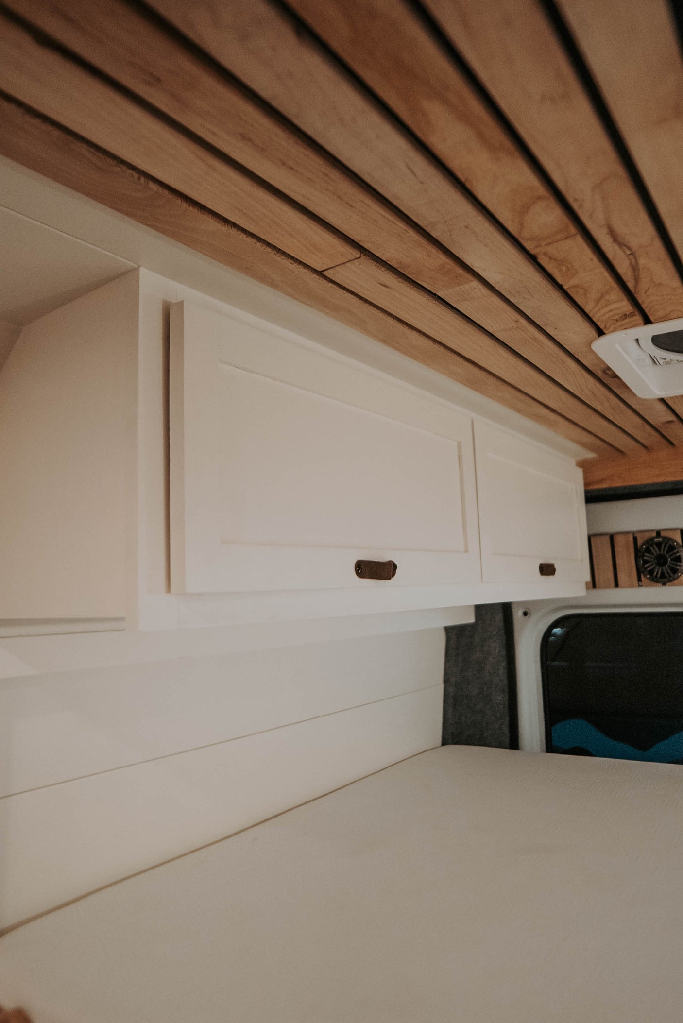 and a clever pull-out extension board for compact spaces.|Cozy RV rental interior showcasing built-in seating