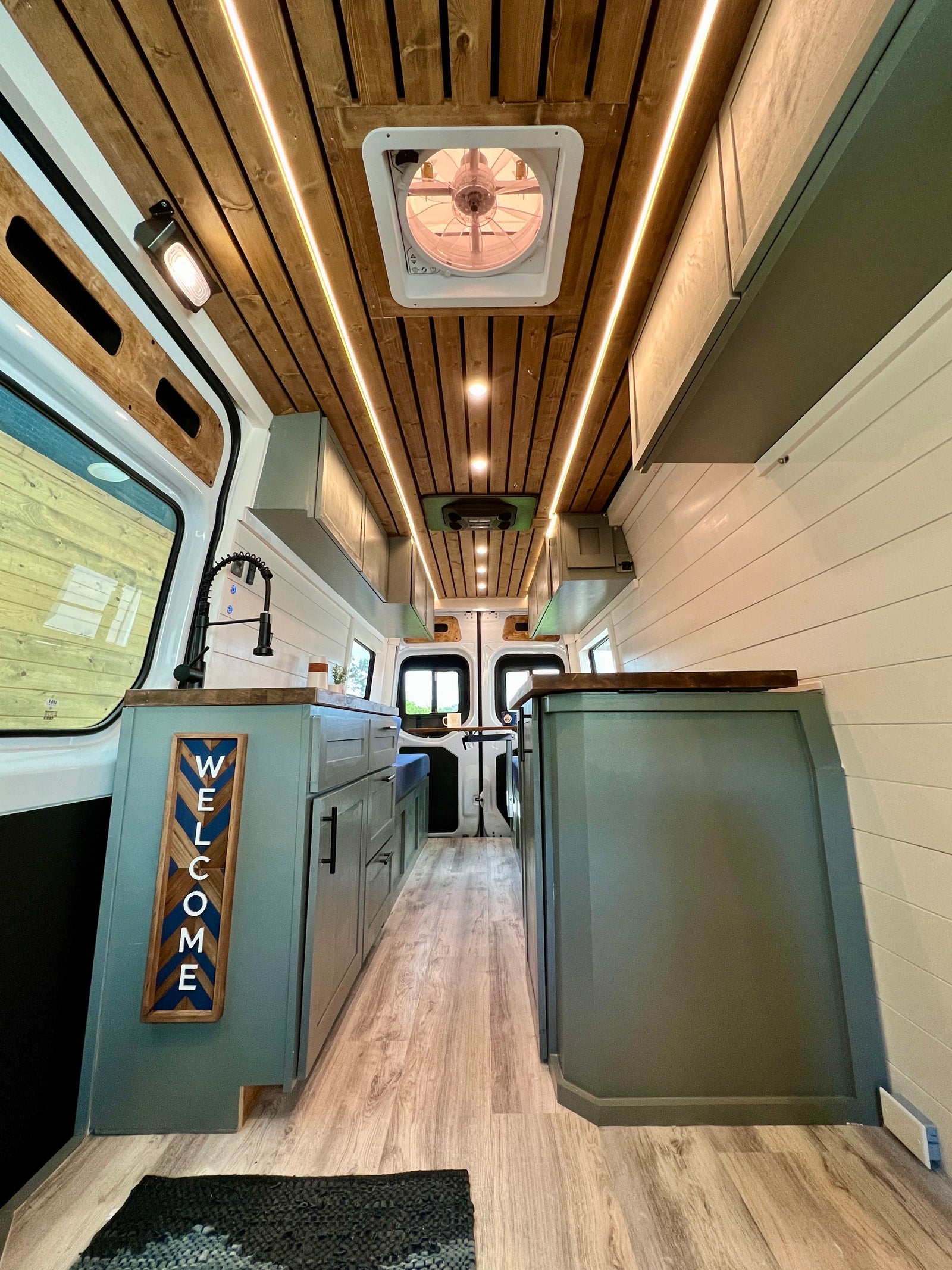 and rich wood countertop.|Bright RV rental interior