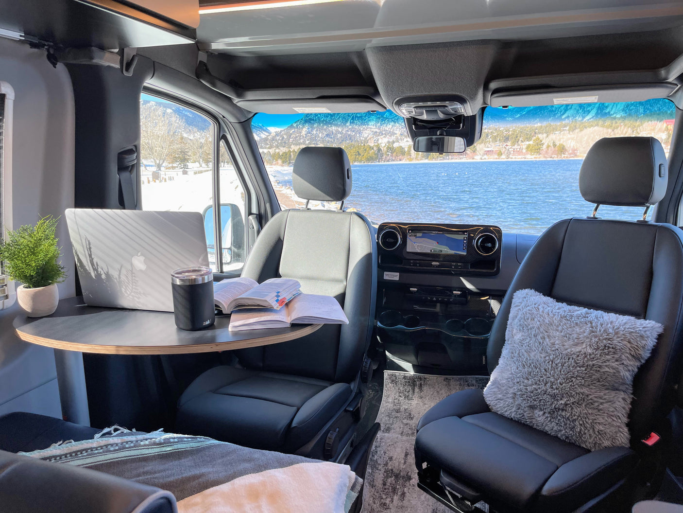 Cozy RV rental workstation with stunning lake and mountain views. Perfect for remote work on the go!