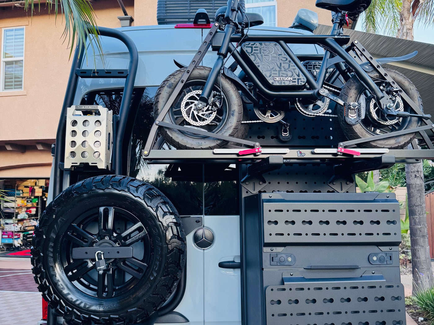 with all-terrain tires and a roof ladder.|Explore in this custom Mercedes Sprinter camper van! Perfect rv rental with open side door — photo 12