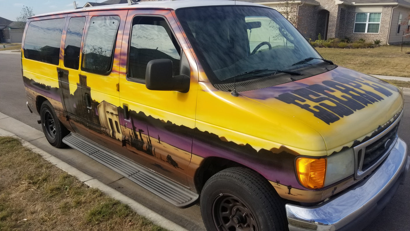 Custom-painted Ford van, ideal for rv rental adventures. Features an 'ESCAPE' hood and a vibrant desert mural side.