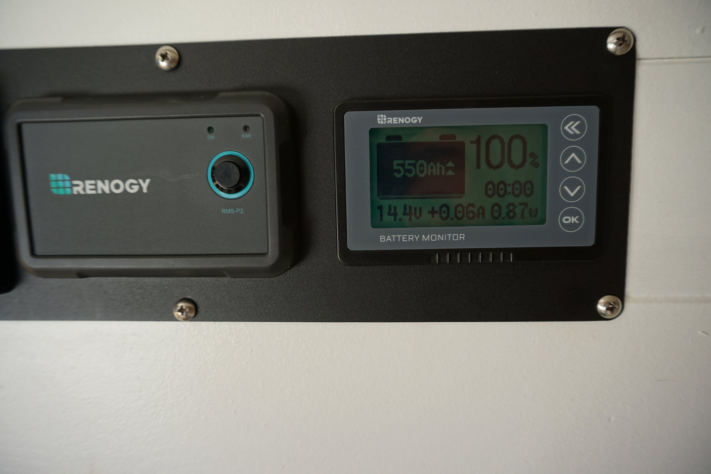 Renogy battery monitor and RMS-P2 controller in an RV rental, showing 100% charge and 550Ah capacity.