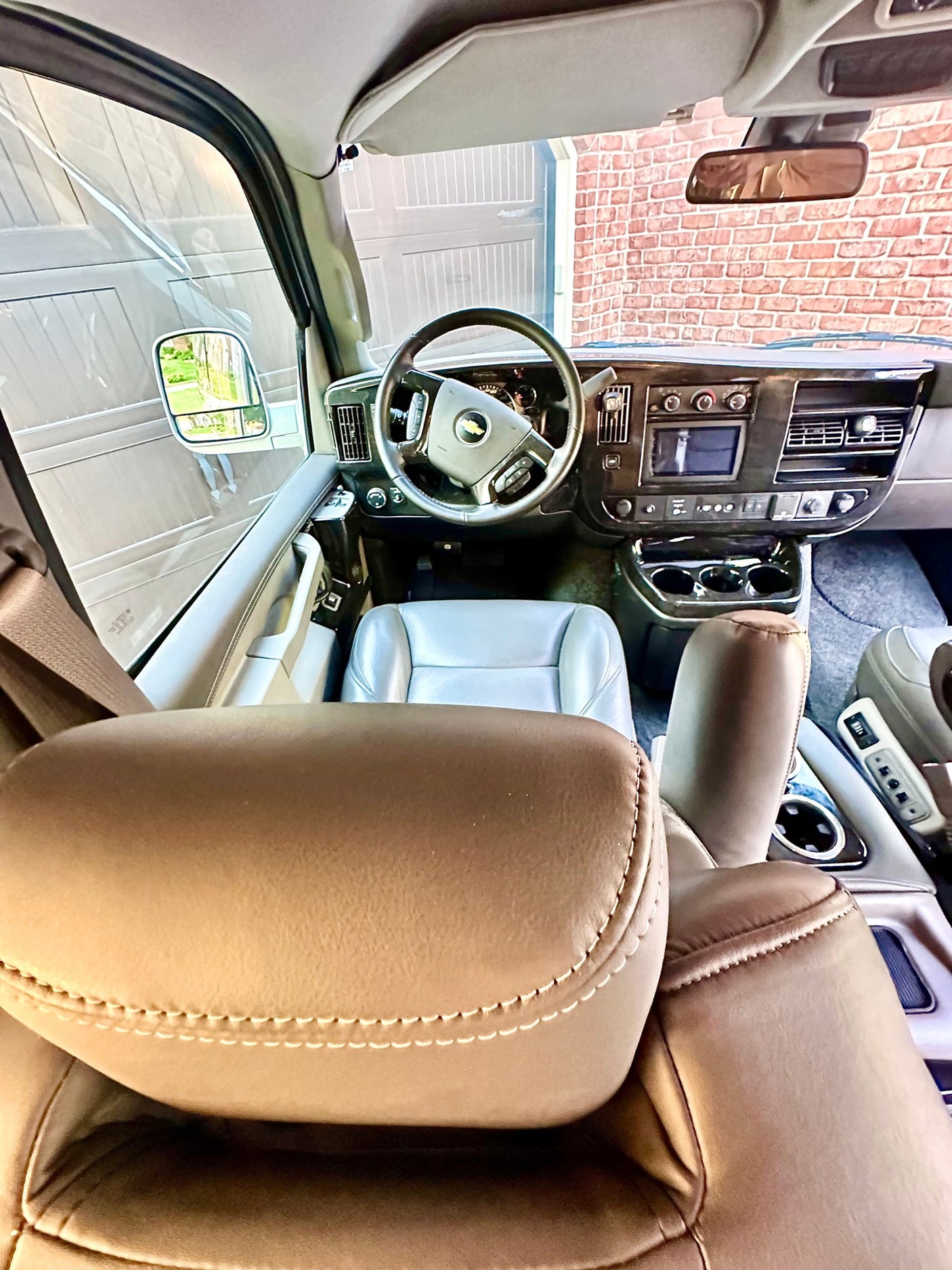 and a ceiling-mounted TV for comfort.|Inside a luxurious RV rental conversion van