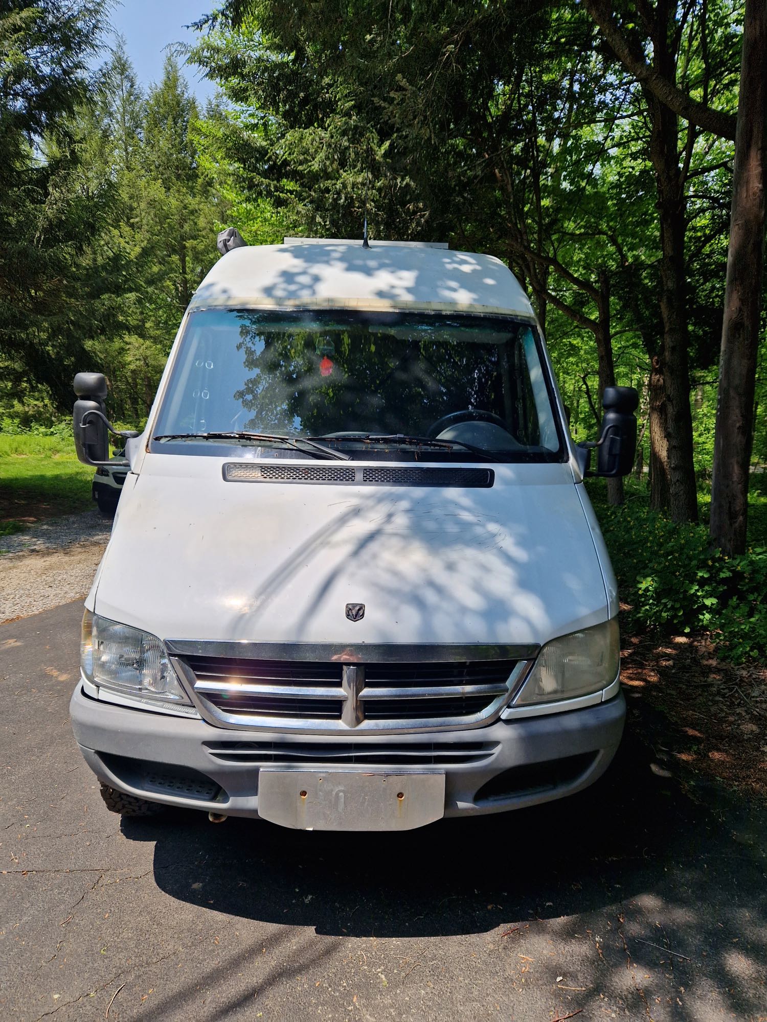 and open drawer with propane tank.|Well-appointed wooden RV rental kitchen: open cabinets with dishes