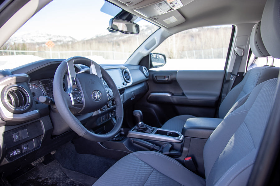 Spacious car interior with steering wheel, dashboard, and front seats. Excellent for your next RV rental journey.