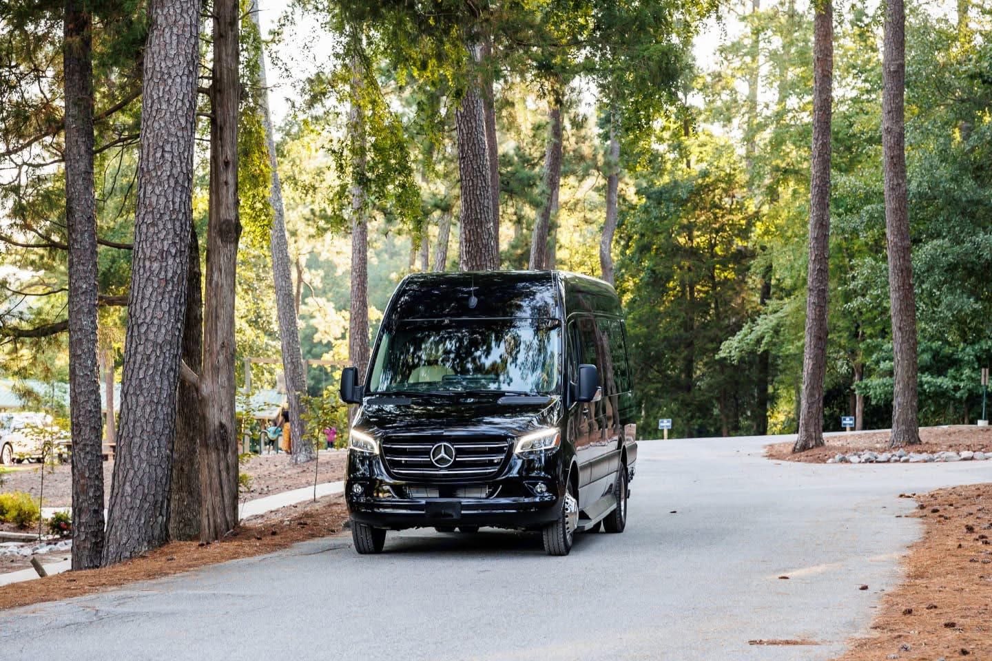 featuring plush beige interior and open side door.|Sleek black Mercedes Sprinter van for rv rental