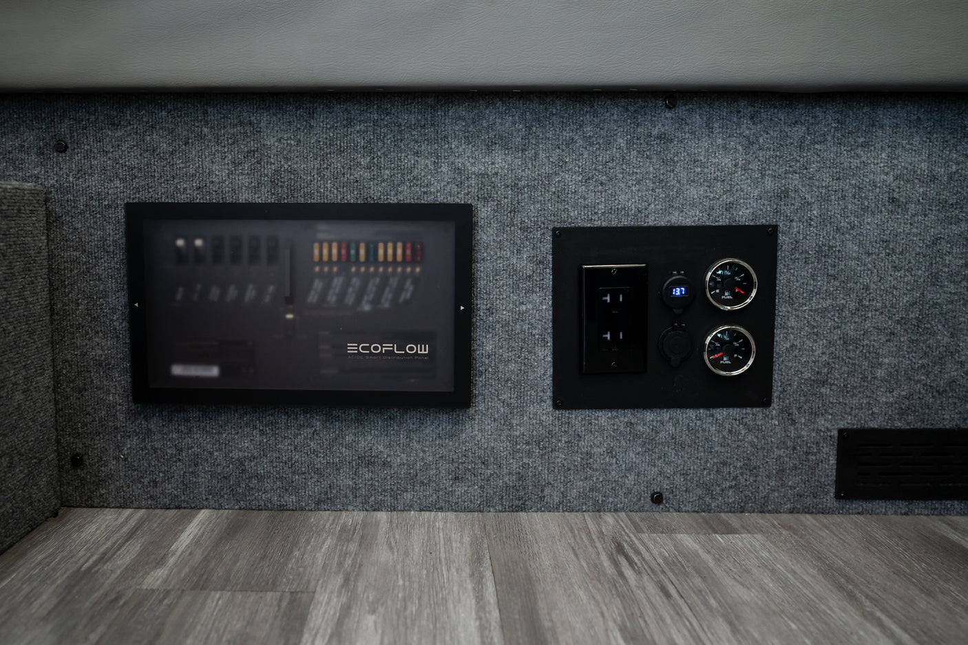 RV rental electrical system. Ecoflow power distribution panel, outlets, and gauges for monitoring inside a camper van.