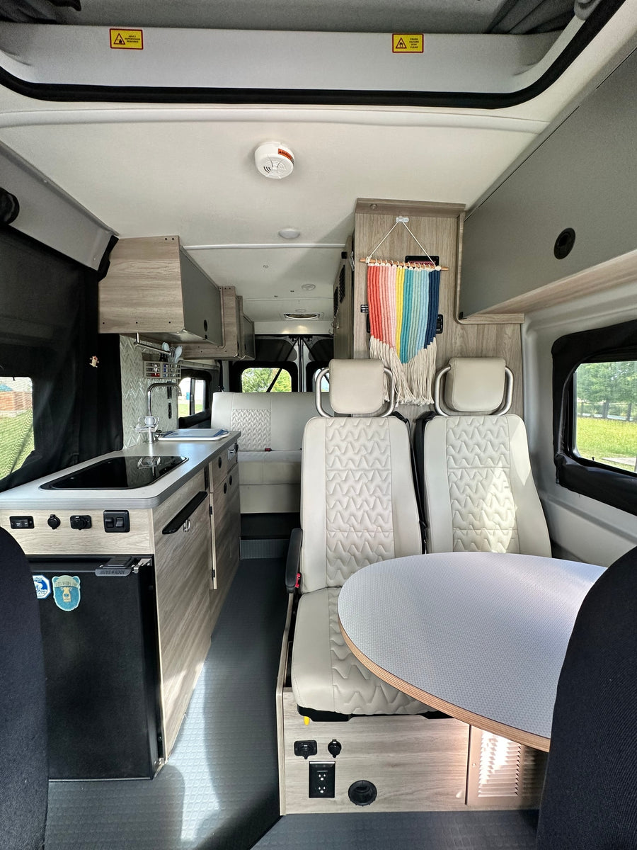 and comfortable front seats.|RV rental camper van interior: Compact kitchen with sink
