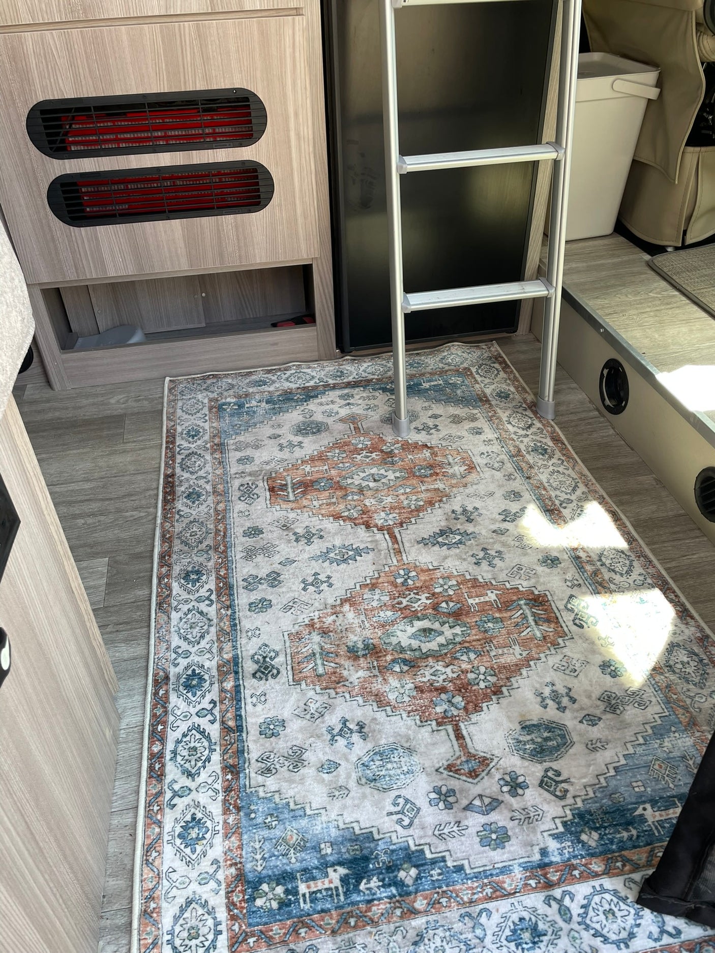 and swivel chairs. Ideal for travel.|Compact RV rental kitchen featuring a sink