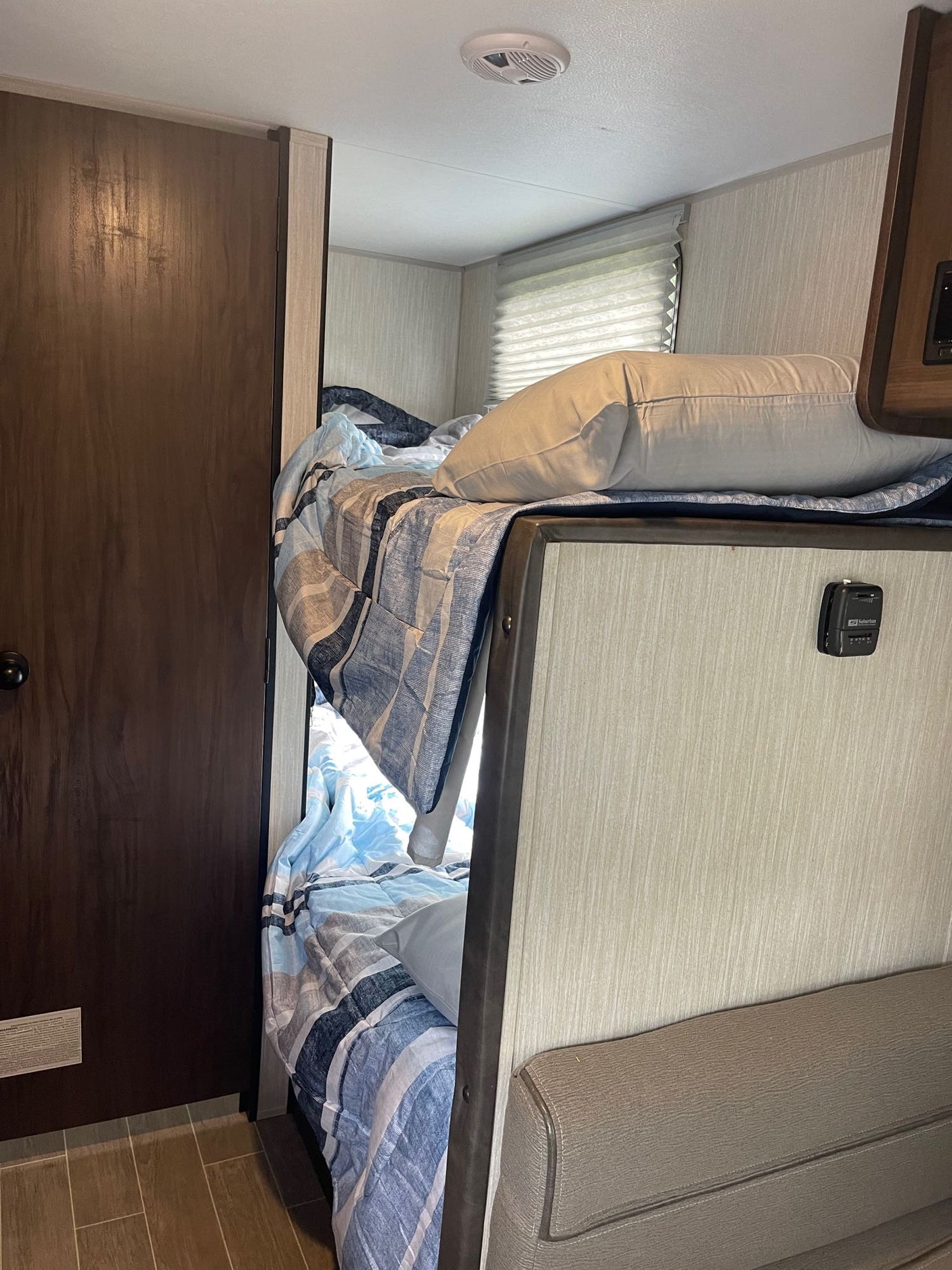 parked on a green lawn.|This silver Wolf Pup travel trailer is ready for your next adventure. Consider this RV rental parked on lush green grass.|A Forest River Wolf Pup travel trailer