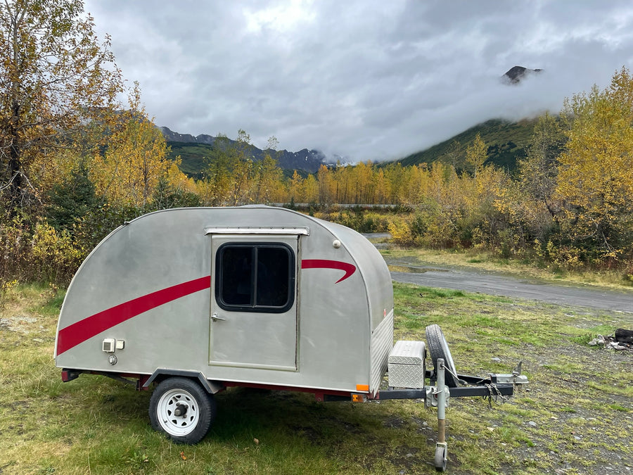 ideal for nature adventures.|Cozy rv rental sleeping nook with wood-paneled walls