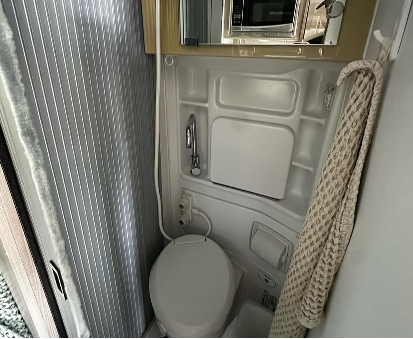 and entertainment amenities.|Inside this modern RV rental: compact kitchen with sink