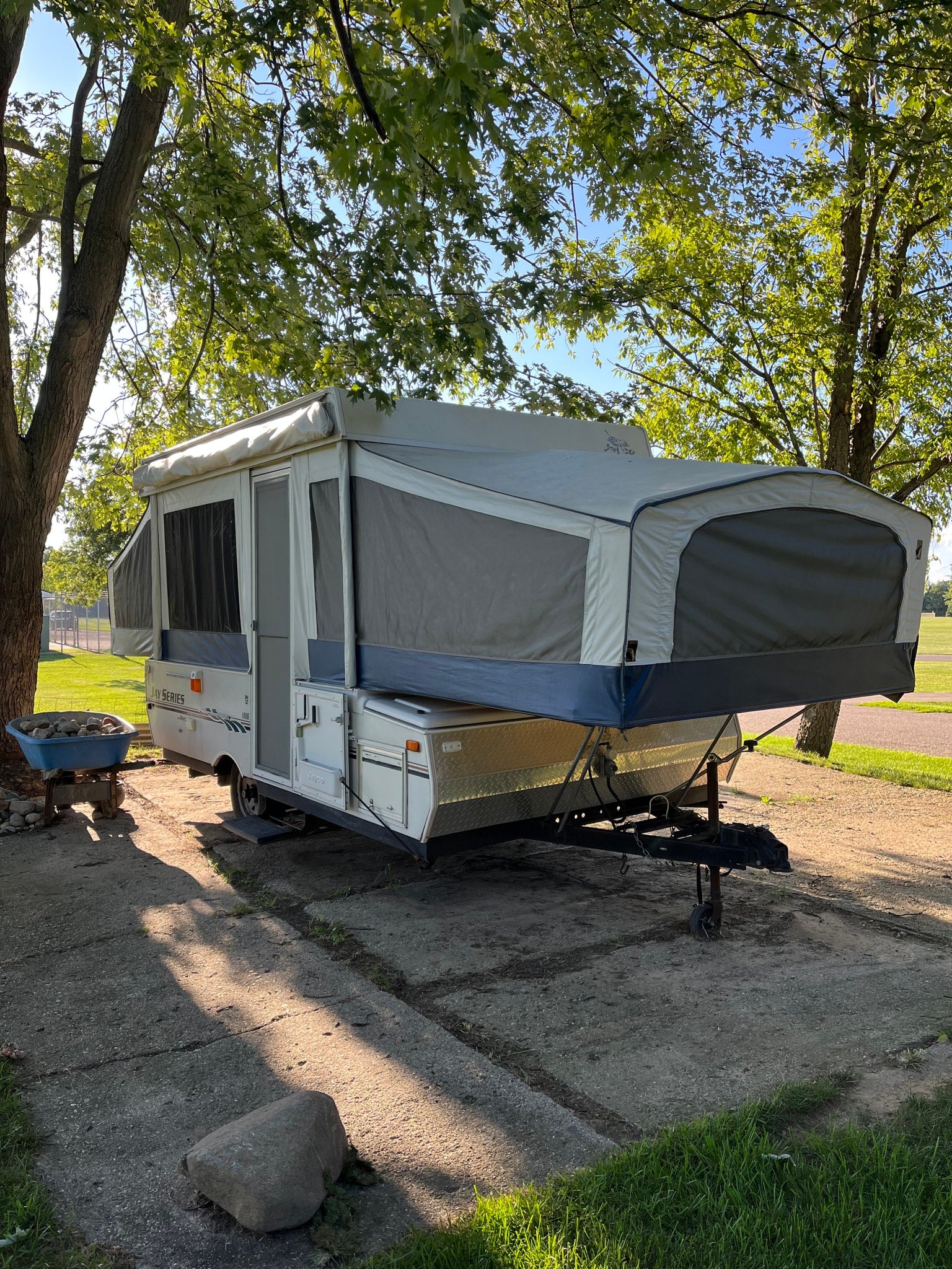 A white and gray pop-up camper