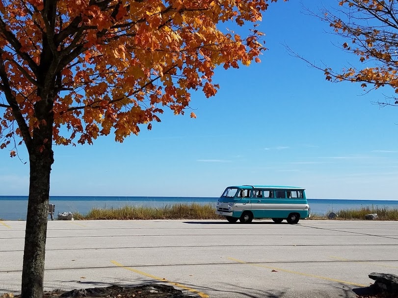 and comfy seating for your road trip.|Detailed interior of a vintage camper van RV rental with pop-top roof