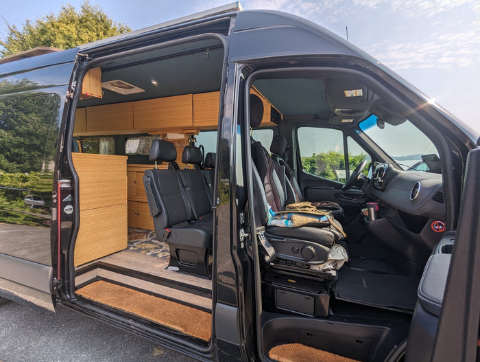 and side galley with sink. A camper van setup.|Cozy bamboo interior of an RV rental