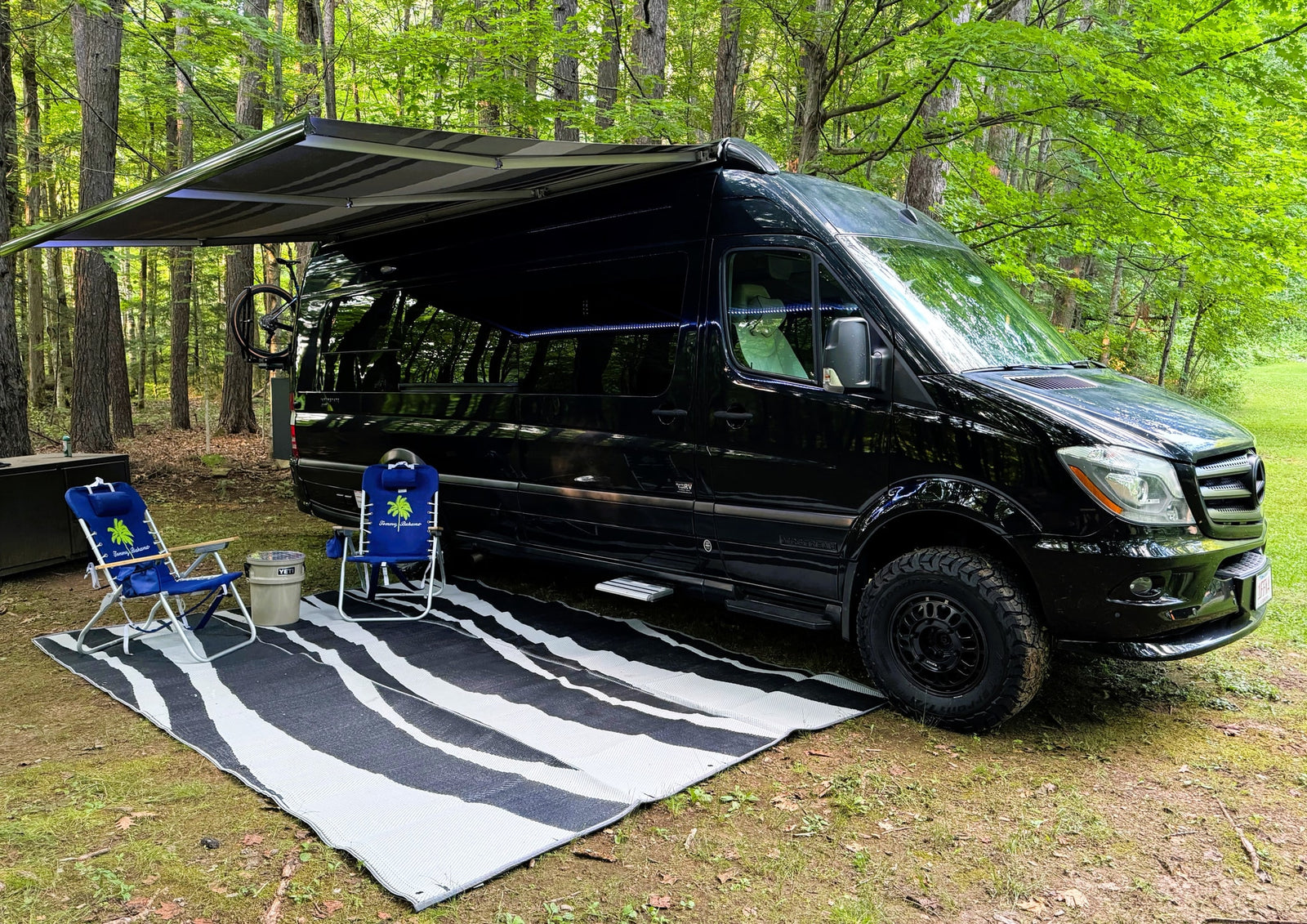 Black camper van with awning extended