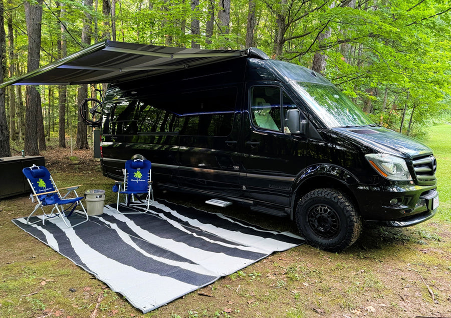 Black camper van with awning extended