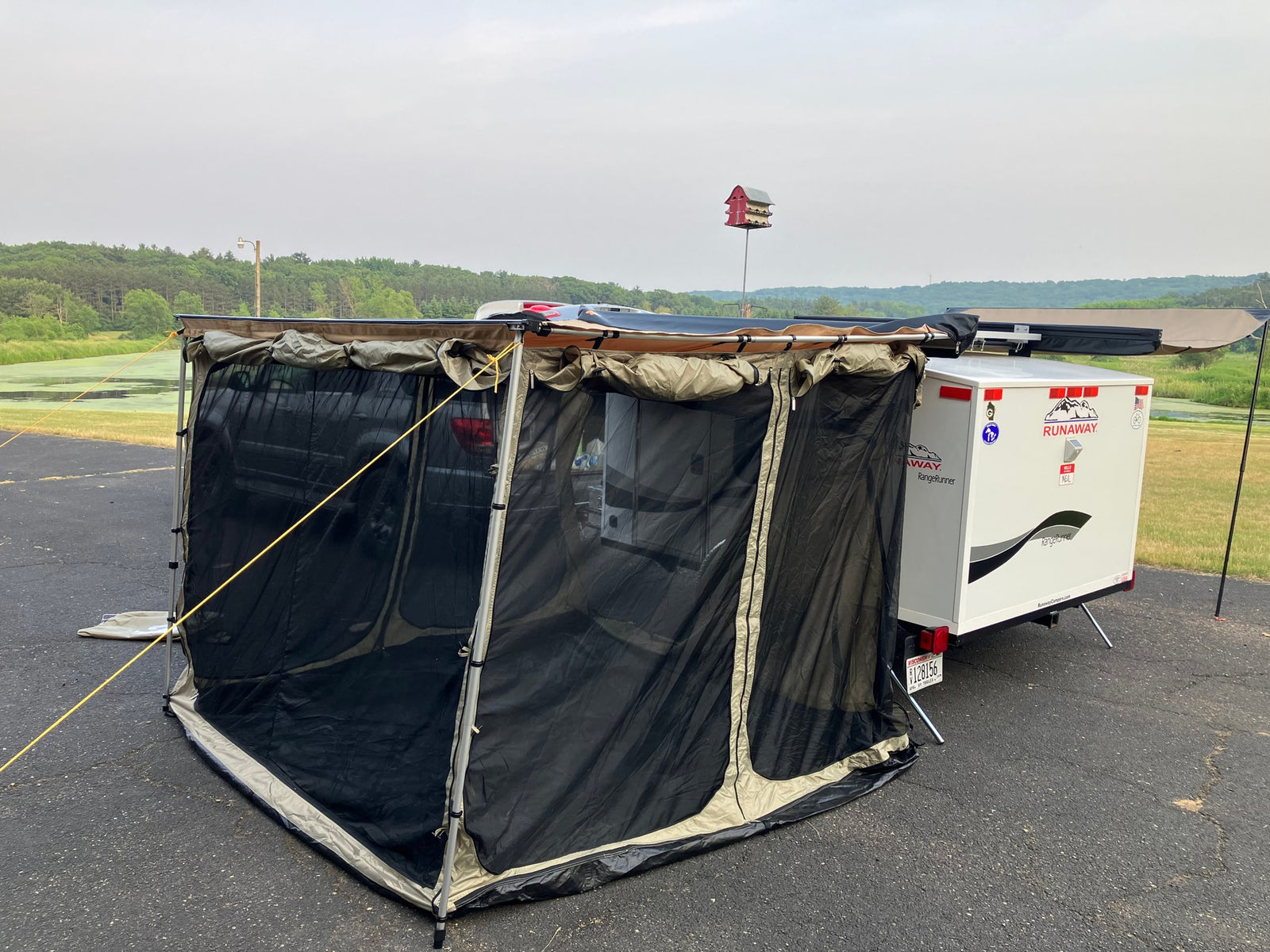 RV rental example: Runaway camper & vehicle with a large screen room for outdoor use.