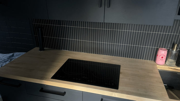dark grey kitchen in an RV rental with light wood counters