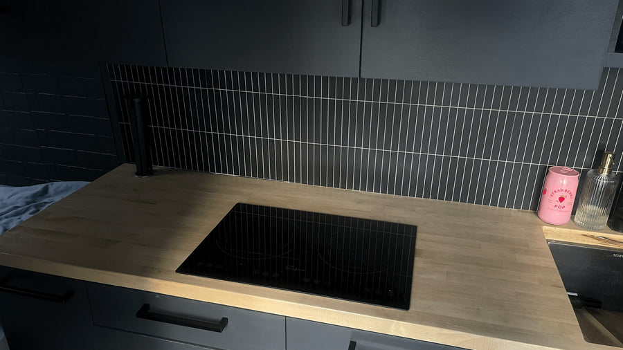dark grey kitchen in an RV rental with light wood counters