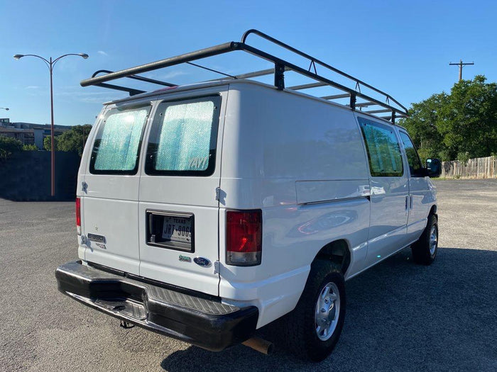 reading a book by the river at sunset. Cozy van life scene.|Step inside this RV rental's camper van interior. Features include wooden paneling