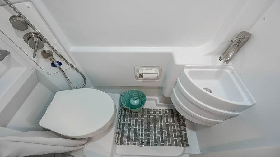 This rv rental wet bath features a space-saving toilet, corner sink, and shower for your travels.