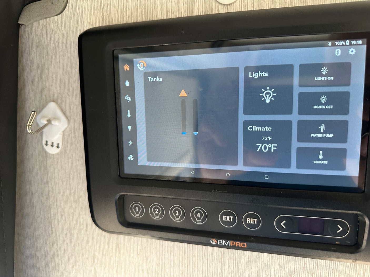 An rv rental's smart control panel: Manage tanks, lights, climate (73°F/70°F), and water pump features.