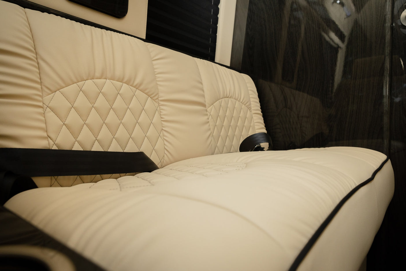 quilted leather bench seat with a black seatbelt inside a clean RV rental