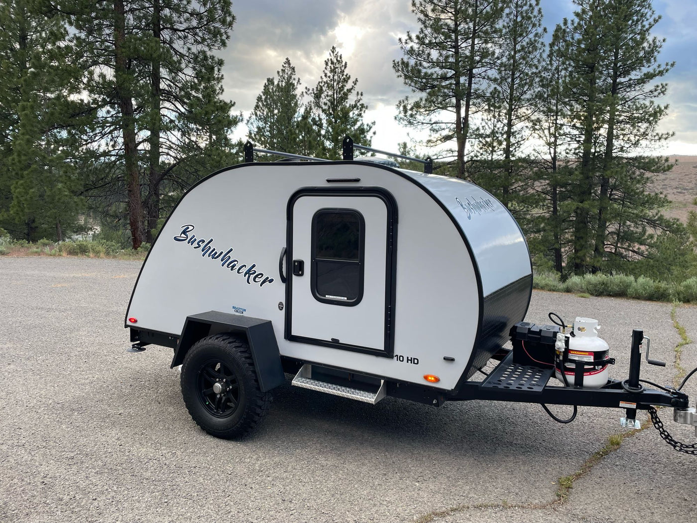 found in an RV rental kitchen.|This **RV rental** features a practical utility sink with a flexible blue coiled sprayer hose for convenience.|An olive green K2 Summit 30 cooler — photo 18