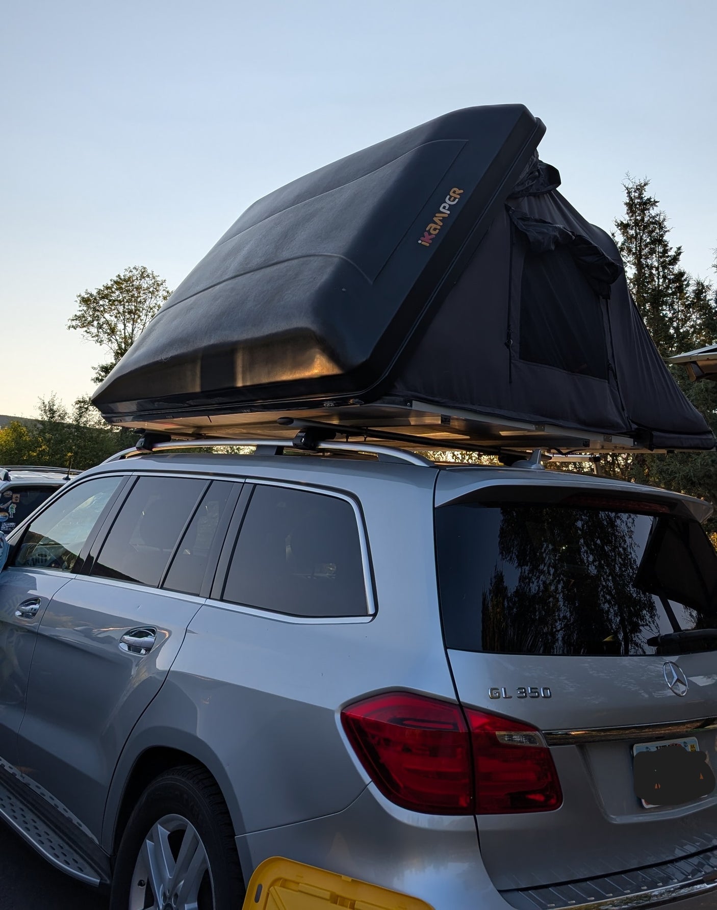 Silver Mercedes-Benz GL 350 SUV with a deployed iKamper rooftop tent. Perfect for an outdoor adventure or rv rental!